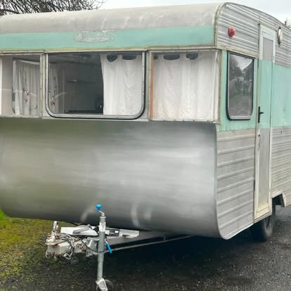 The finished caravan with polished aluminium lower panels, mint green upper panels and a new jockey wheel